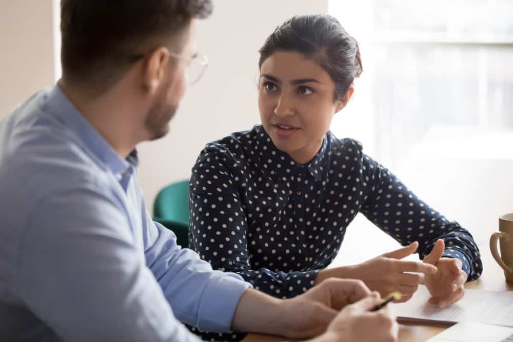 Young,Indian,Female,Mentor,Coach,Worker,Talking,To,Male,Coworker